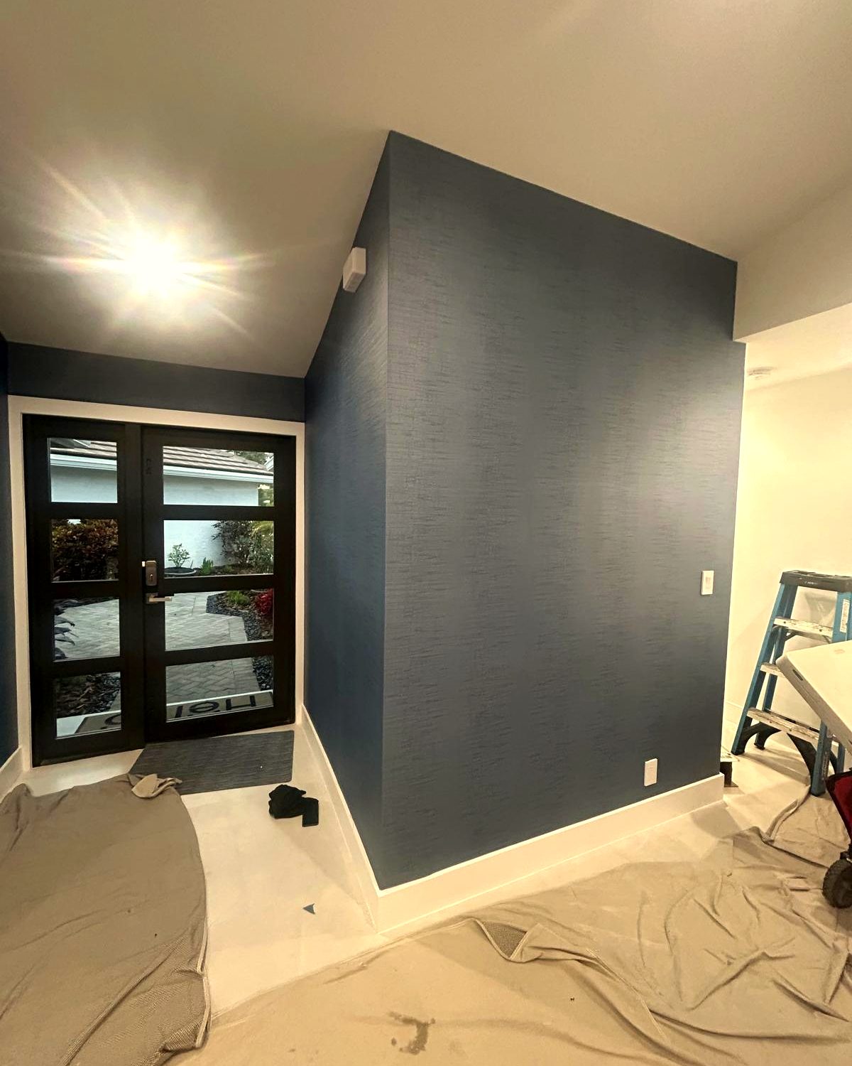 A Dream Wall Studio job in progress, with the floor fully covered before any wallcovering goes up.