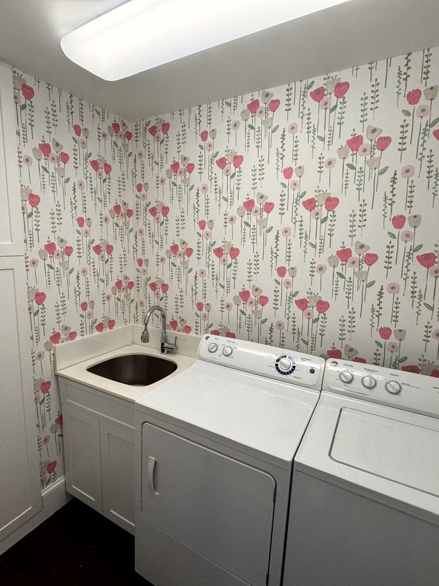 Poppy print, laundry room. Carried around three walls and over the machines, with the pattern staying level across the cabinet run.