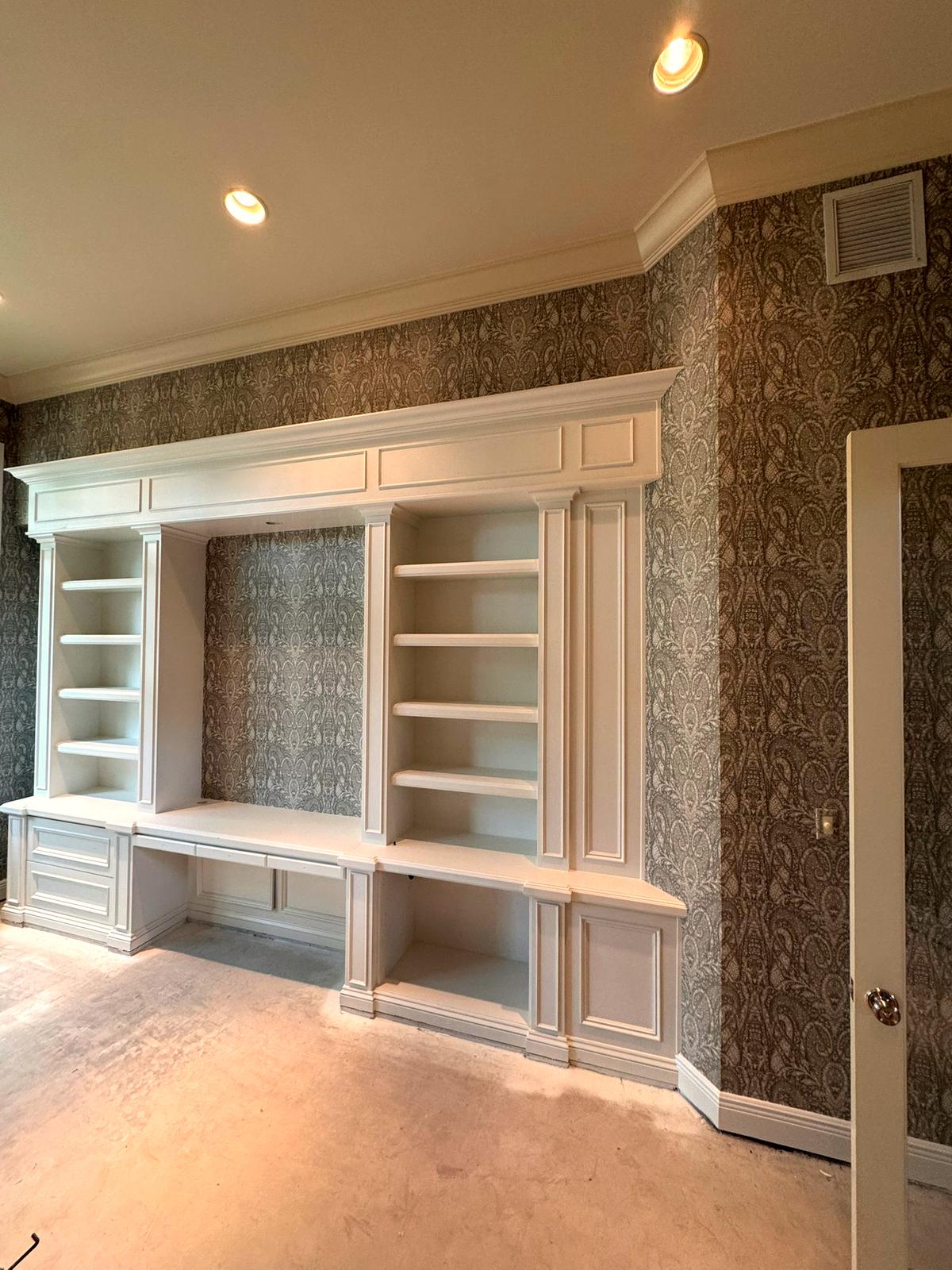 Wallcovering behind built-in millwork. Hung behind and between finished cabinetry, where every cut is visible and nothing can be hidden by trim.