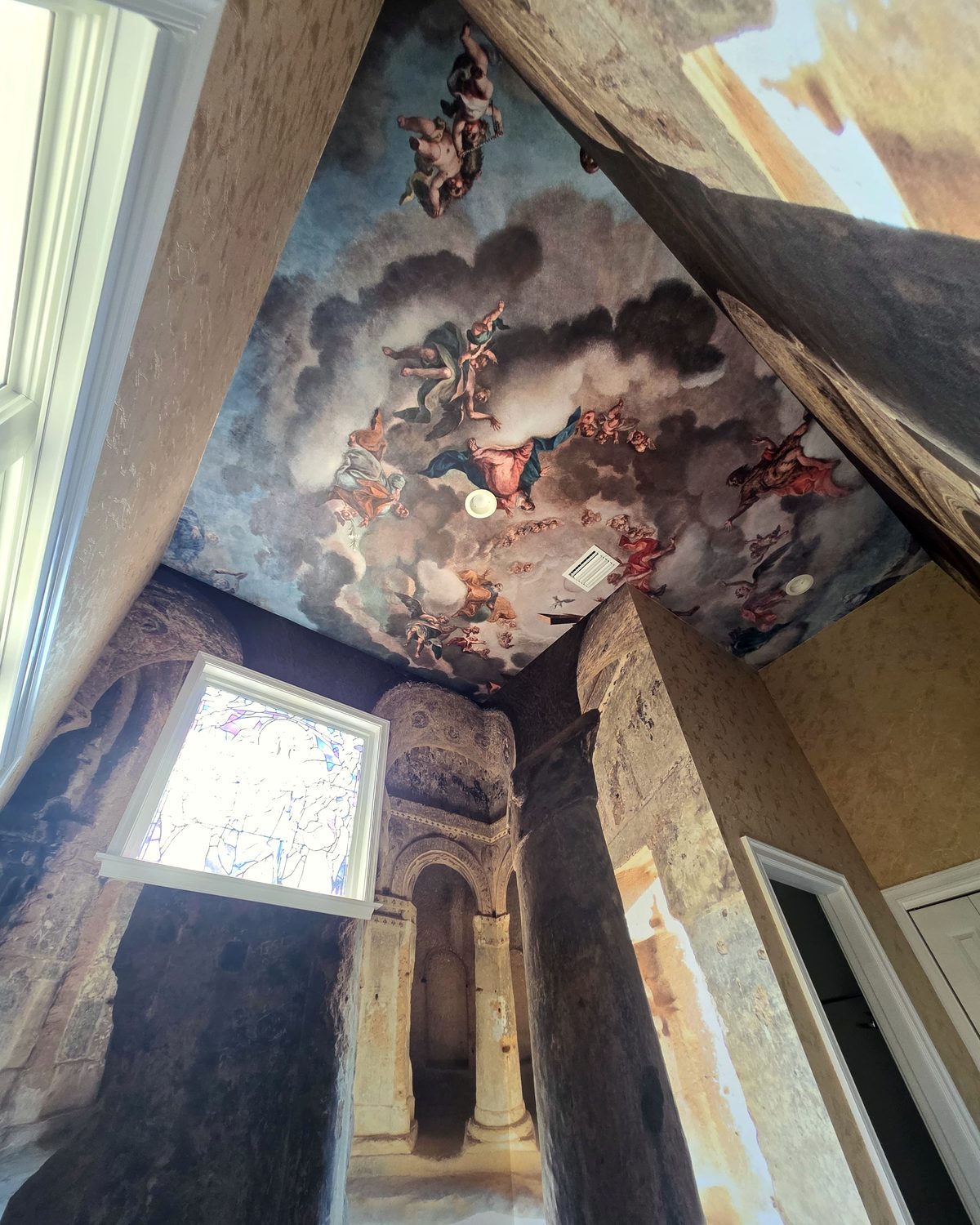 Baroque sky mural installed across a vaulted ceiling and stairwell walls by Dream Wall Studio